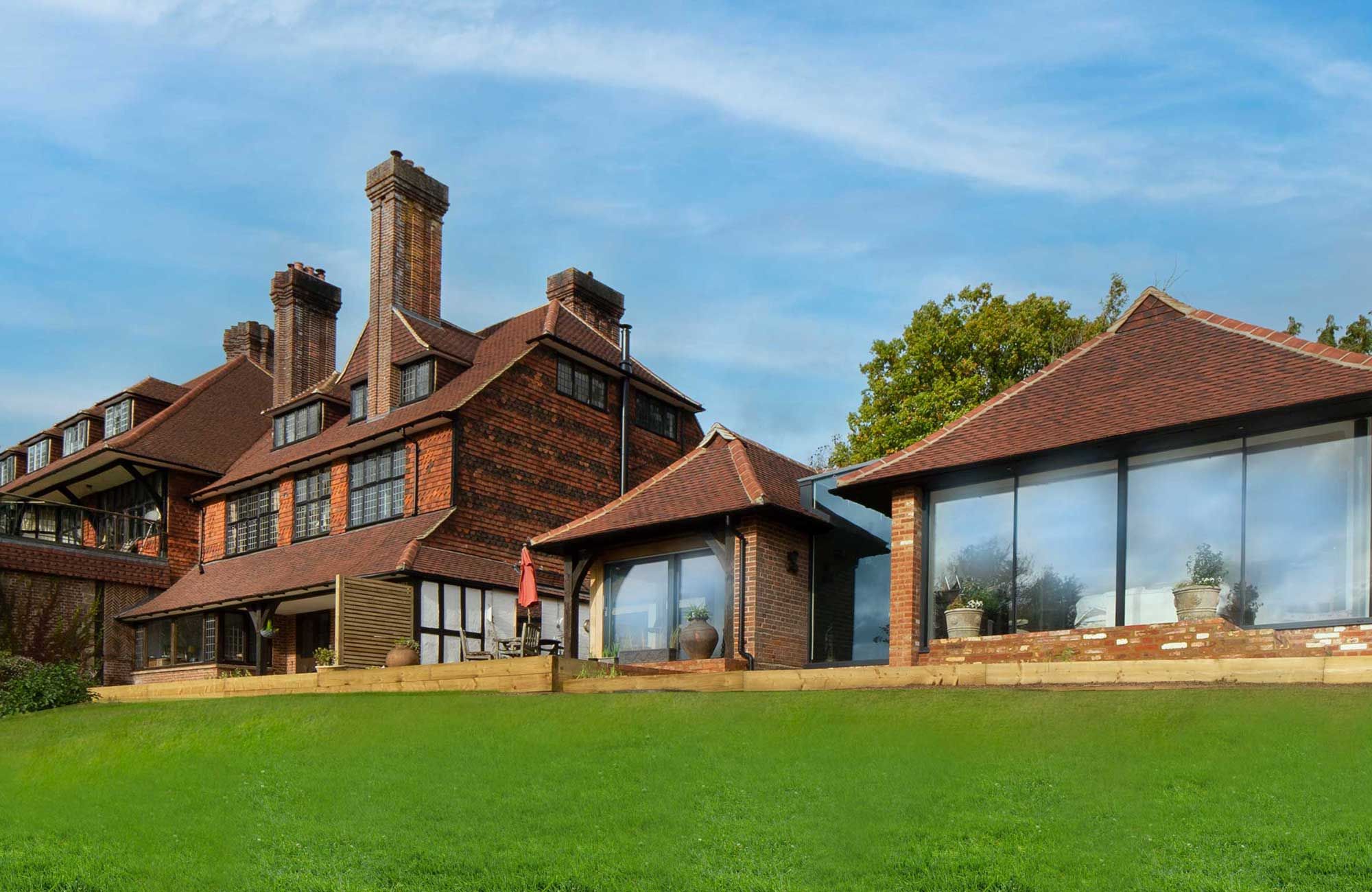 Country house exterior showing brick, tile-hung upper floor and chimneys