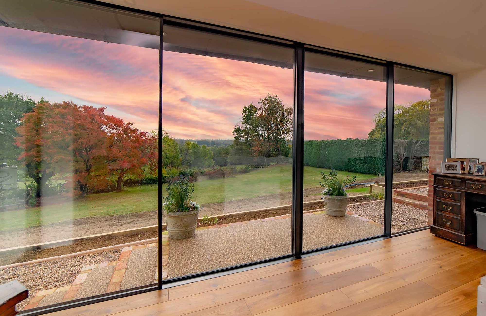 Sliding glass doors overlooking the garden at sunset, country house renovation
